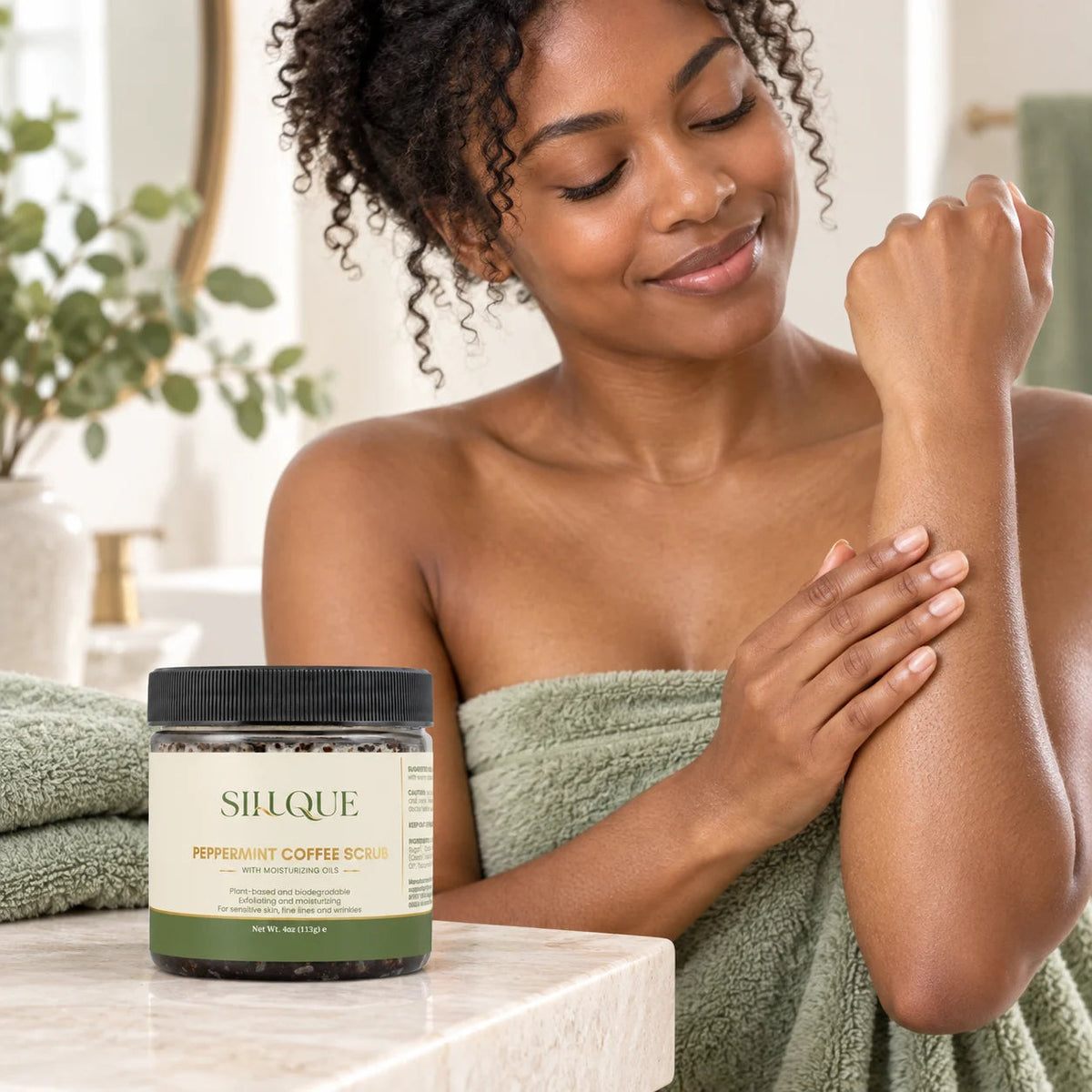 Sillque Peppermint Coffee Scrub beside a woman touching her freshly rinsed forearm