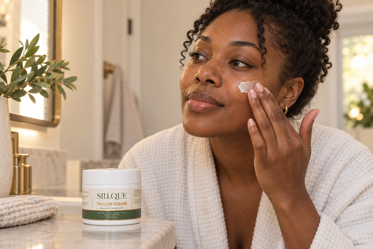 Black woman applying Sillque Tallow Cream during her evening routine